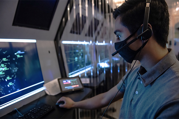 A UA student wears a headset and reads data from a display