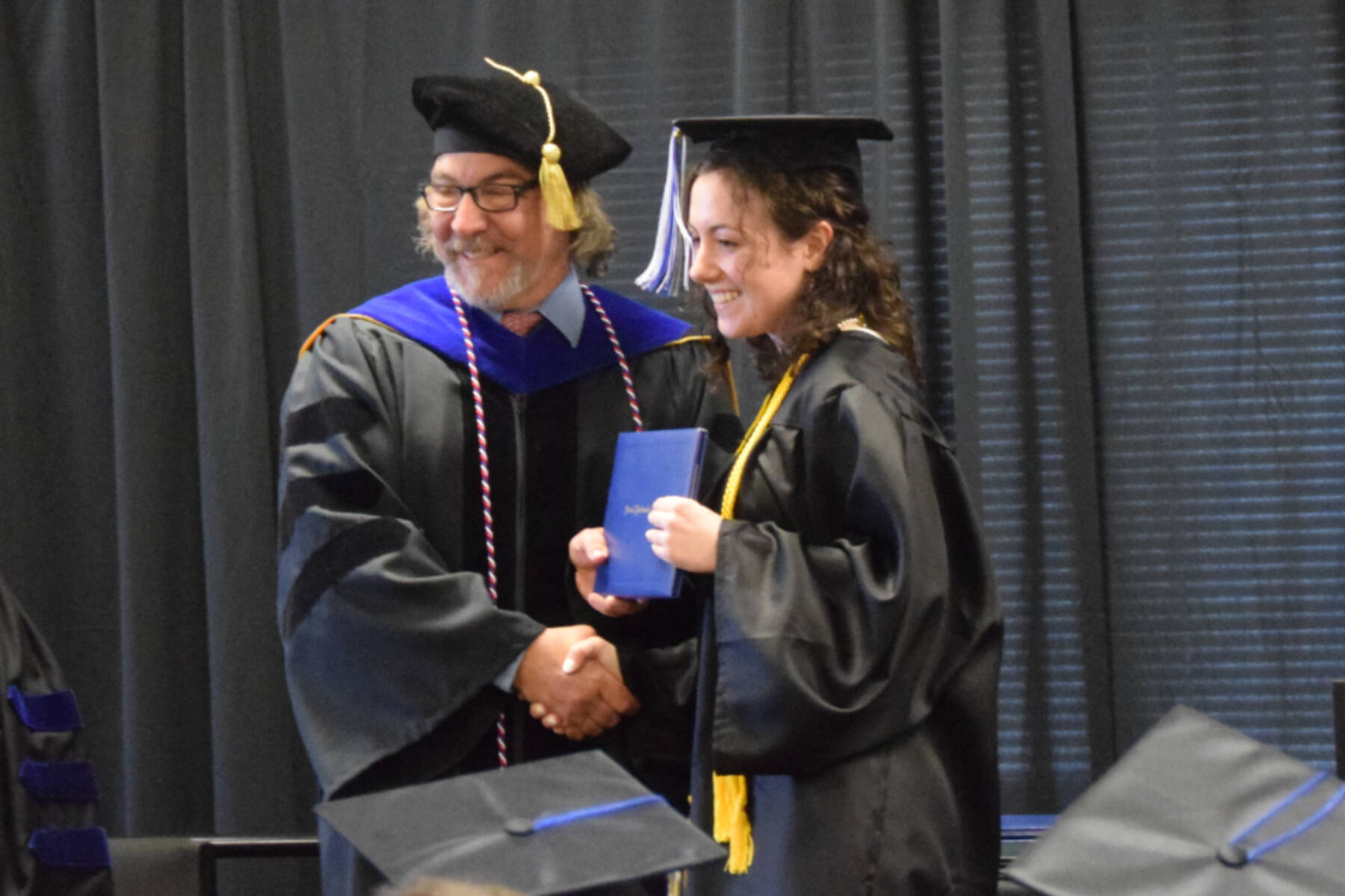 Kachemak Bay Campus Director Dr. Reid Brewer (left) presents valedictorian Elizabeth Rozeboom (right) with her Associate of Arts diploma during the 2023 KBC Commencement on Wednesday, May 10, 2023 in 猫咪视频r, 猫咪视频.